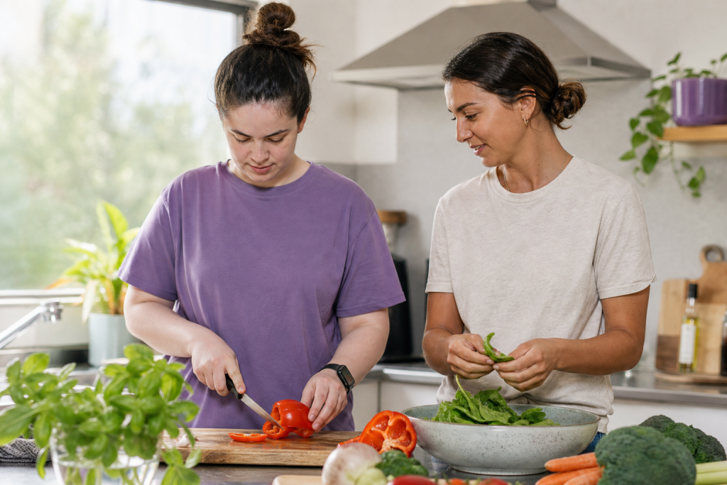 Young adult and mentor preparing a healthy meal
